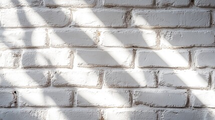 Textured white brick wall with sunlight shadows, perfect for background