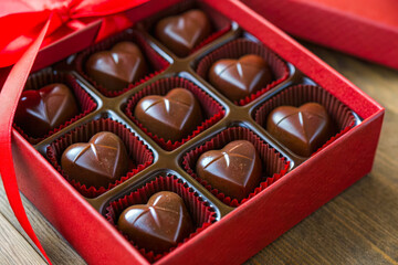 a box of chocolates with a red ribbon