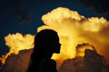 A solitary figure stands out against the soft, gray clouds