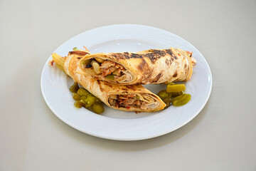 Lavash doner kebab ( soslu kasarli zurna doner durum )  or shawarma sliced in plate isolated.  Tavuk Et Doner Durum. Hatay Iskenderun usulu bazuka, zurna  tavuk doner durum. 