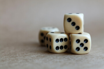 dice on a beige background, close-up 