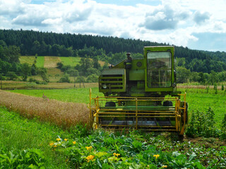 Fototapeta premium An old combine harvester abandoned in a field