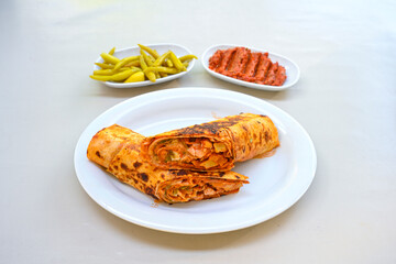 Lavash doner kebab ( soslu kasarli zurna doner durum )  or shawarma sliced in plate isolated.  Tavuk Et Doner Durum. Hatay Iskenderun usulu bazuka, zurna  tavuk doner durum. 