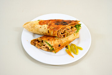 Lavash doner kebab ( soslu kasarli zurna doner durum )  or shawarma sliced in plate isolated.  Tavuk Et Doner Durum. Hatay Iskenderun usulu bazuka, zurna  tavuk doner durum. 