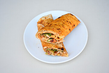 Lavash doner kebab ( soslu kasarli zurna doner durum )  or shawarma sliced in plate isolated.  Tavuk Et Doner Durum. Hatay Iskenderun usulu bazuka, zurna  tavuk doner durum. 