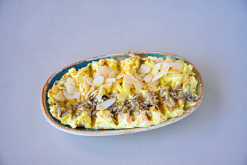 With garlic yogurt in bowl. ( Turkish name; havuc tarator) Carrot tarator in ceramic bowl with vegetable on light background.