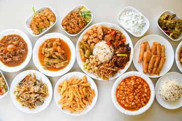 Delicious meat kebab with fresh vegetable salad served with variety of Turkish dishes and appetizers. Top view of assorted Turkish food and meze, tasty and healthy Mediterranean cuisine.