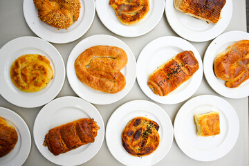 Turkish style meat stuffed filo dough borek served kol boregi.Cheese and minced pie are sliced on a marble background. Turkish name: Kol Boregi, kiymali, peynirli su boregi. Ci borek. Kafkas cig borek
