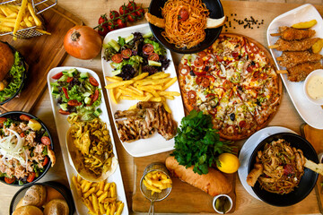 Traditional Turkish cuisine. Pizza, pita, pidesi, sucuk, hummus, kebab. Many dishes on the table. Serving dishes in restaurant. Margherita,  mix, formaggi, veggie karisik pizza. Top view, flat lay