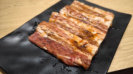 Korean style grilled beef on a black plate