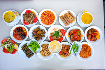 Delicious meat kebab with fresh vegetable salad served with variety of Turkish dishes and appetizers. Top view of assorted Turkish food and meze, tasty and healthy Mediterranean cuisine.