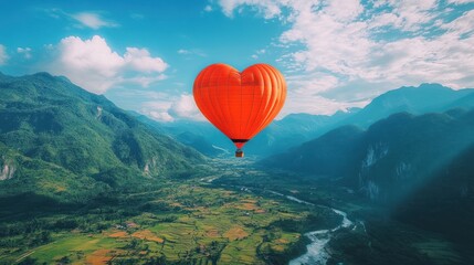 Fototapeta premium A vibrant hot air balloon shaped like a heart floats over a lush valley, showcasing the beauty of nature and leisure travel.