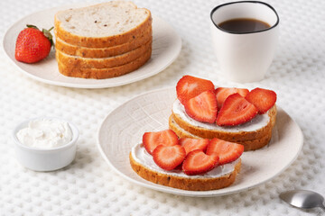 Homemade Crispbread toast with Cottage Cheese and Strawberry on white table