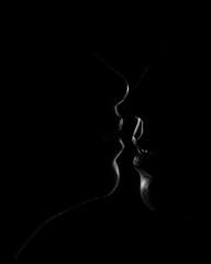 two girls kissing dark low key