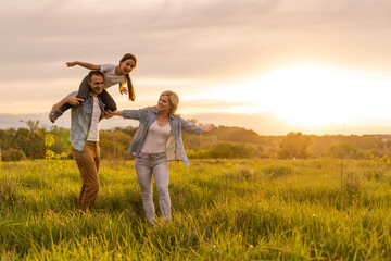 family is walking in a field