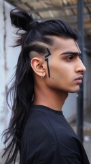 Fototapeta premium Stylish man with long black hair, and shaved sides with tribal face art.