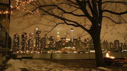 Night cityscape view with bonfire and snow.