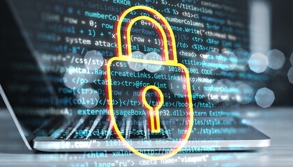 Laptop screen with digital lock icon overlay and programming code in background, representing cybersecurity and data protection.