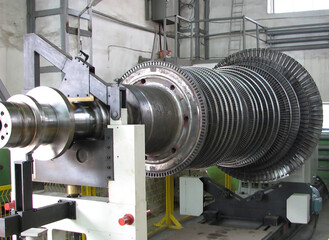 Industrial medium pressure turbine rotor on a balancing machine in a workshop. Mechanical...