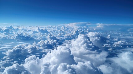 Aerial view of fluffy white clouds against a vibrant blue sky.