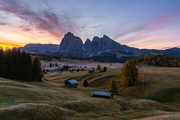 Alpe di Siusi at sunrise with a magnificent pink sky lighting up the alpine meadow