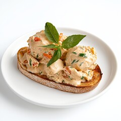 Creamy salmon spread served on whole grain toast garnished with fresh basil leaves, blending nutritious seafood flavors with rustic breakfast or brunch presentation