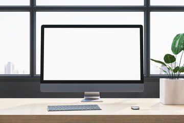 Fototapeta premium Desktop computer with blank screen on wooden desk in modern office interior with large windows, plant, and city view. 3D Rendering