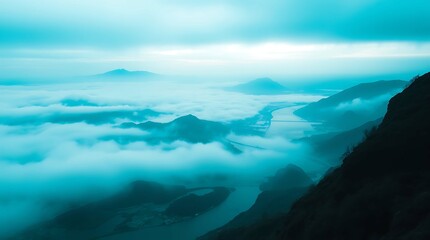 Obraz premium A breathtaking aerial view of a valley shrouded in a soft, pastel blue mist