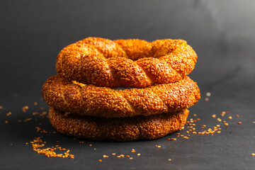 Savory sesame rings stacked elegantly on a dark surface