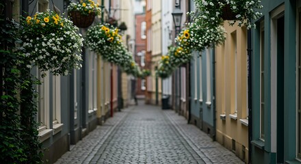 Fototapeta premium Quaint cobblestone alleyway lined with vibrant hanging flower baskets and colorful buildings, concept for travel brochure, urban exploration and cityscape photography