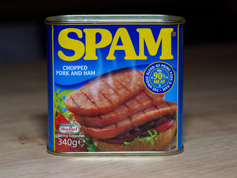 SPAM canned meat product by Hormel Foods, displayed on a wooden surface.