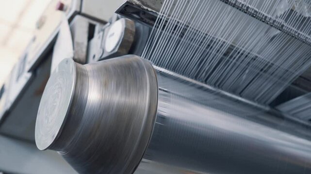 Operation of a flat-slot extruder in the production of polypropylene bags.