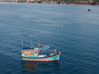 Aerial view, top view of fishing boat anchored on the sea. Royalty high quality free stock of Wooden fishing boats are moored with ropes to the pier on Mui Ne, Binh Thuan, Vietnam	
