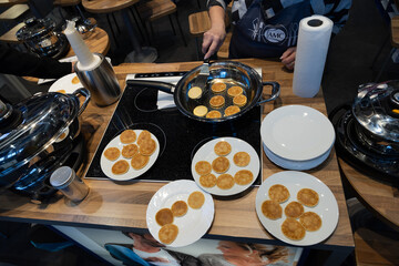 Frying mini pancake cereal in a nonstick frying pan.
