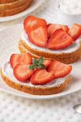 Homemade Crispbread toast with Cottage Cheese and Strawberry on white table