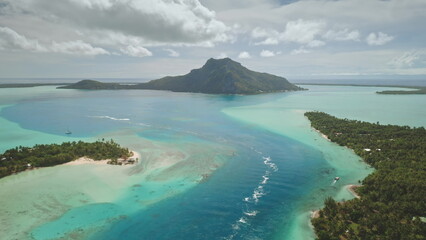 Breathtaking aerial perspective of Maupiti island in French Polynesia, vibrant turquoise lagoon...
