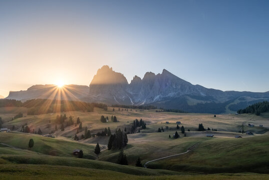 Sunrise over the Seiser Alm alpine meadows with the Dolomites mountain peaks in the background, South Tyrol, Italy