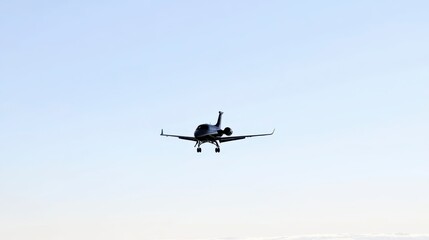 Obraz premium An aircraft approaches landing against a clear blue sky, showcasing aviation and the beauty of flight.