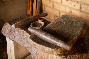 The Mexican stone metate in Oaxaca is an ancient stone tool for grinding food products.