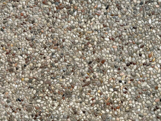 Close up of cemented pebbledash or roughcast coral stones in many colors. Composed of small random cut various pebble stones colors. Suitable for garden flooring.