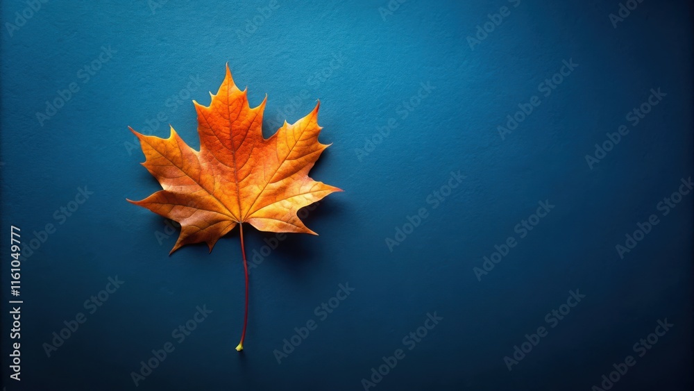 Poster A Single Autumn Leaf on a Blue Background, Illustrating the Transition from Summer to Fall