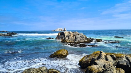 Rocks on a sea shore in summer with rising tide