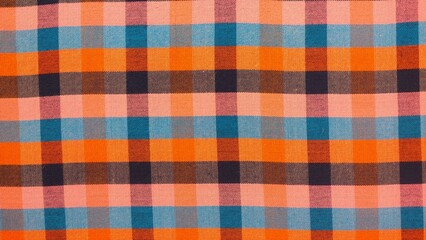 A checkered patterned fabric with blue, orange, and purple colors