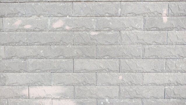 Fototapeta A gray brick wall with a white line