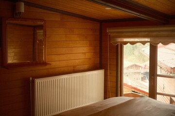 Vintage classic wooden interior with a heating radiator and natural light in a rural mountainous village
