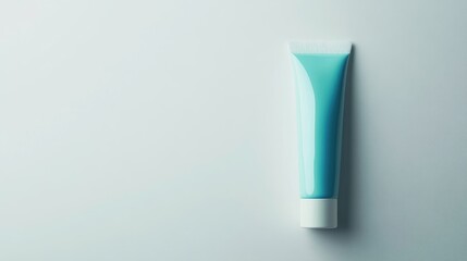 Blue toothpaste tube on minimalist white background showcasing hygiene and personal care products for dental health advertising.
