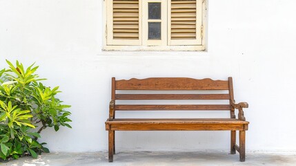 Rustic wood furniture reflects heritage charm. Wooden bench next to a white wall and window with shutters.