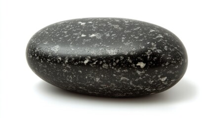 Single black pebble on white background symbolizing resilience uniqueness and simplicity for wellness and mindfulness concepts