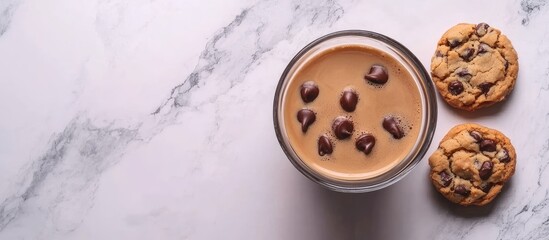 Obraz premium Comfort food flat lay with coffee and chocolate chip cookies on marble surface blank space for text or branding design concept