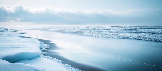 Obraz premium Serene Winter Coastal Landscape with Gentle Waves and Ice Floes on Snowy Shoreline Blank Space for Text in a Tranquil Atmosphere